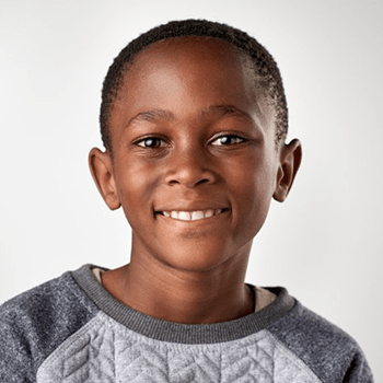 a child smiling after undergoing Invisalign First
