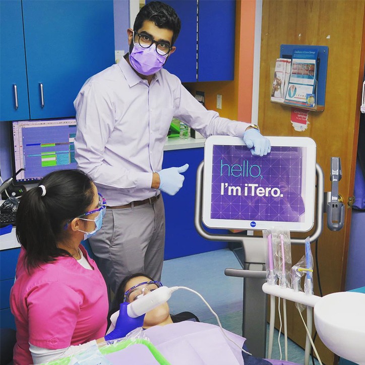 Dentist and patient looking at chairside dental technology system