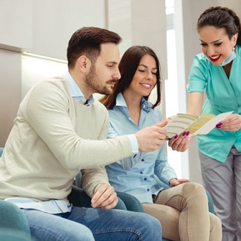 dental team member showing pamphlet to a patient