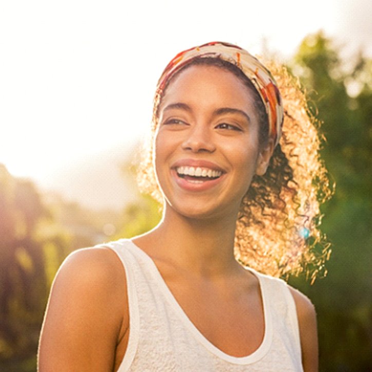 Woman smiling after visiting a cosmetic dentist in Long Beach