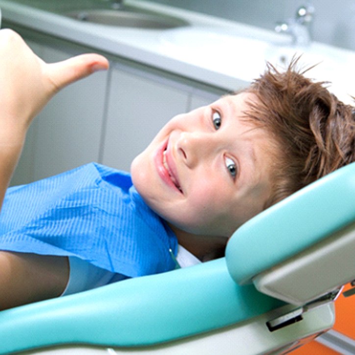 kid giving a thumbs up after getting dental sealants in Long Beach