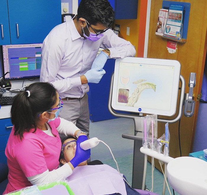Dentist and team member using advanced dental technology