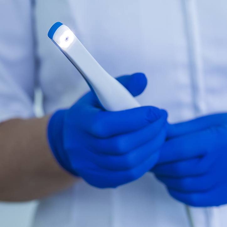 Dentist holding an intraoral camera hand tool