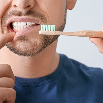 brushing to avoid cost of dental emergency in Long Beach