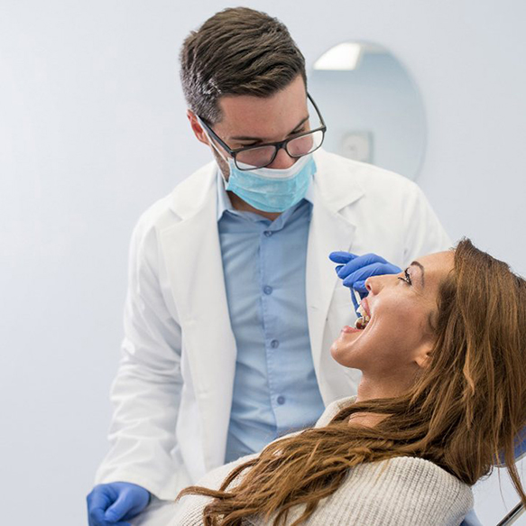 Woman smiling during dental appointment with dentist