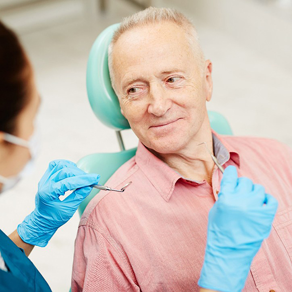 Man softly smiling during his dental appointment