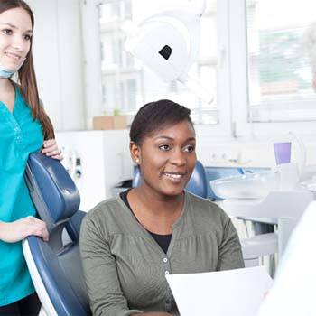 Dentist and patient discussing the cost of dental implants in Long Beach
