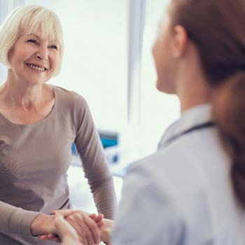 Patient and dentist discussing how to make dental implants affordable in Long Beach