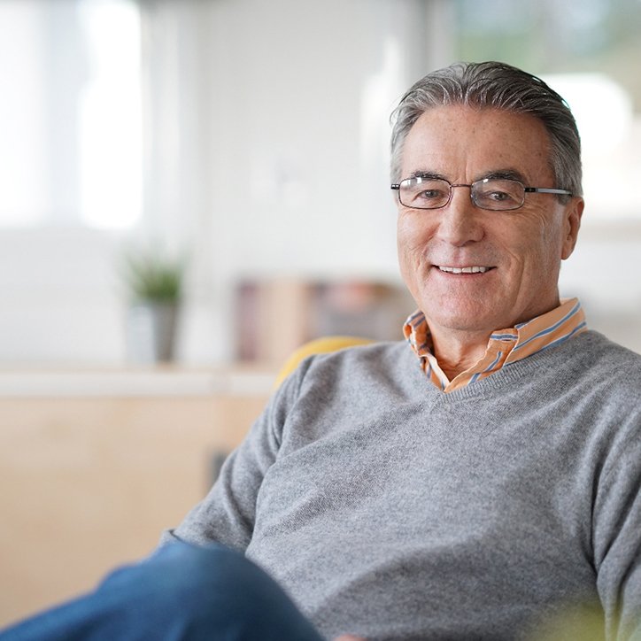 Older man with glasses and grey shirt
