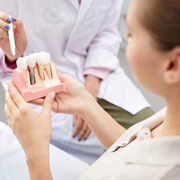 dentist explaining dental implant in Long Beach