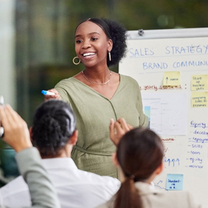 Smiling woman giving presentation at work