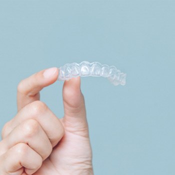 Patient holding Invisalign aligner