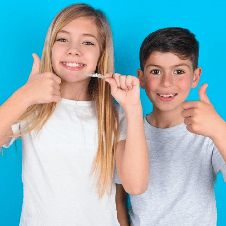 children giving thumbs up while undergoing Invisalign First