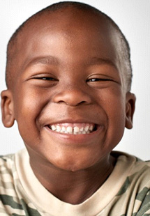 Child smiling brightly on white background
