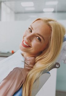 a patient smiling after restoring her teeth