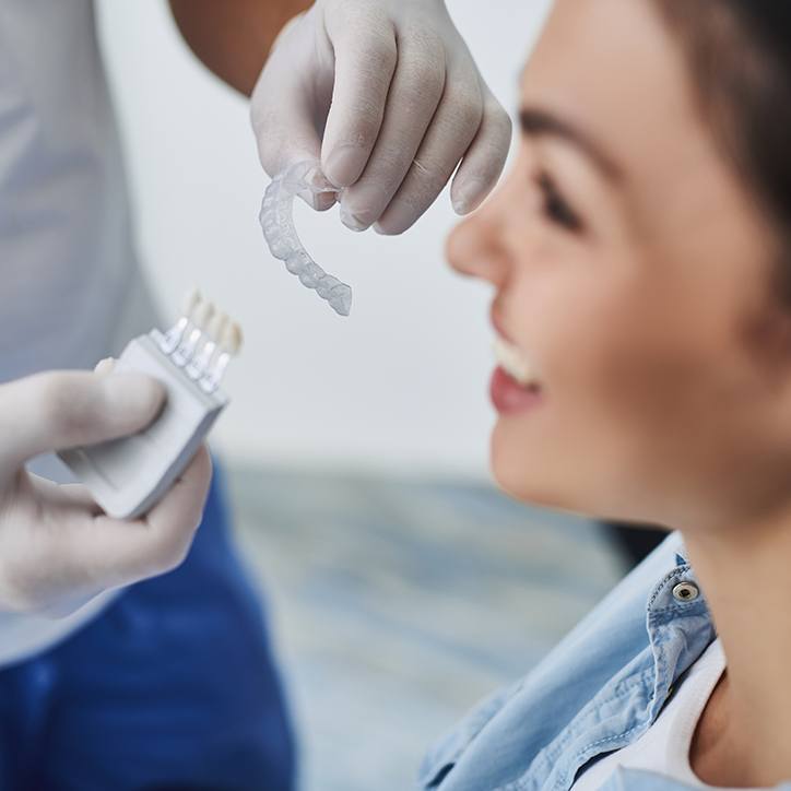 Dentist fitting patient for Invisalign tray