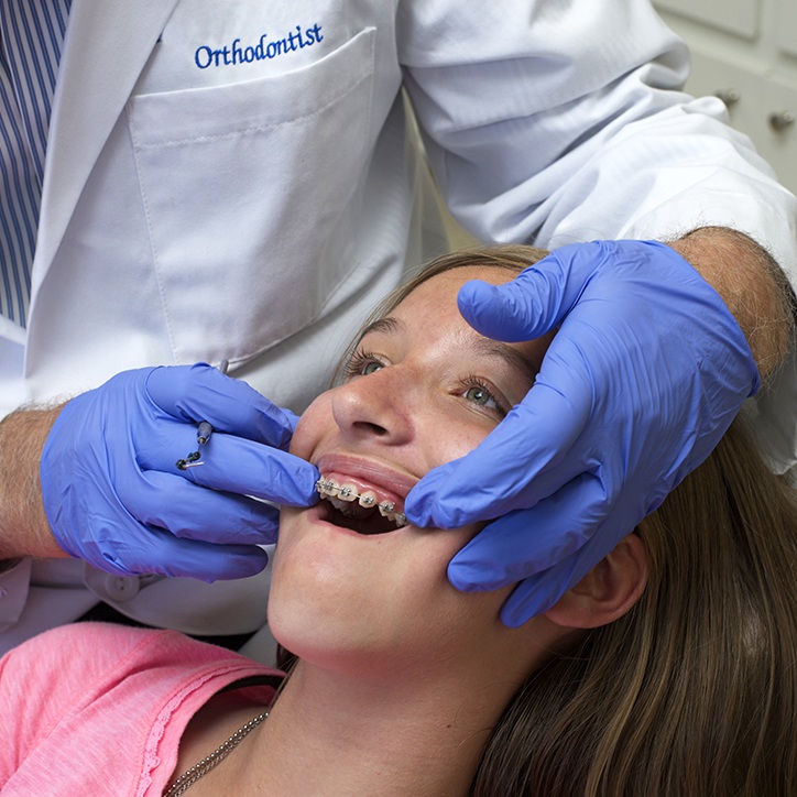 Dentist examining patient with dentofacial orthopedics