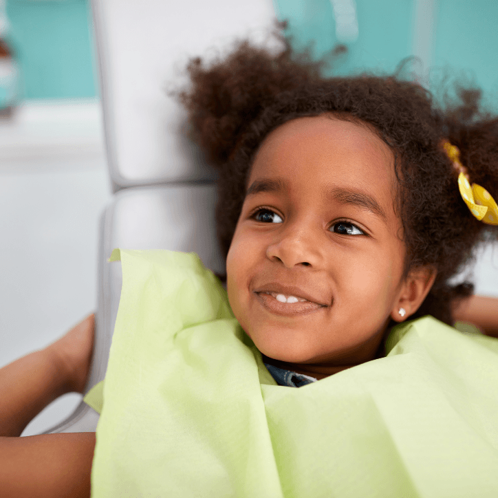 Young girl smiling during children's dental checkup visit