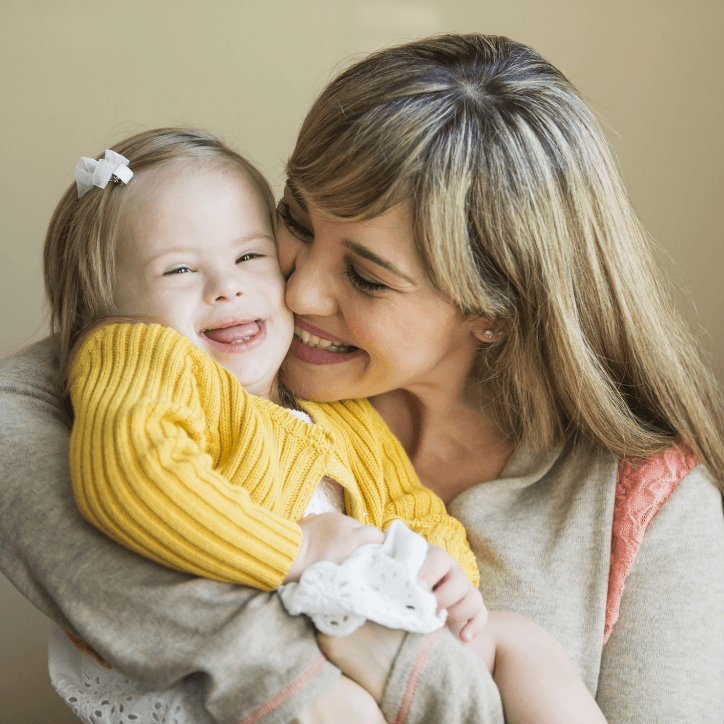 Mother kissing her child's cheek during special needs dentistry visit