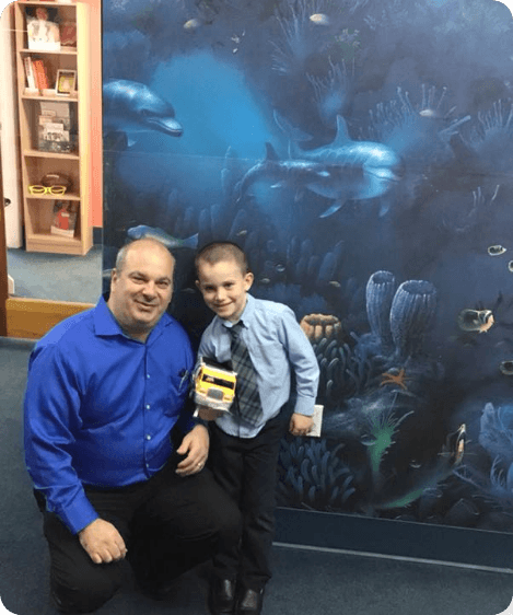 photo of smiling team member with child patient