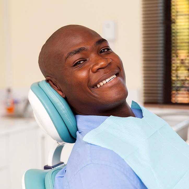 Man smiling during dental checkup and teeth cleaning visit