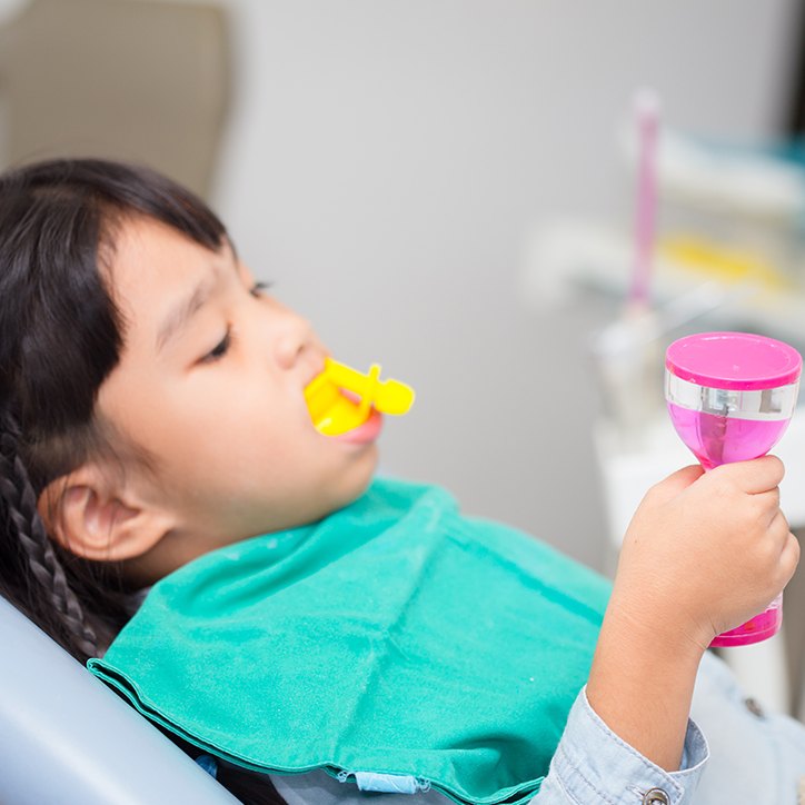 Child receiving fluoride treatment