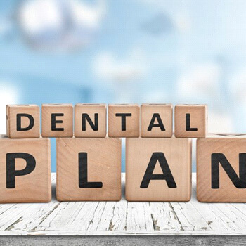an extracted molar on a table with dental tools