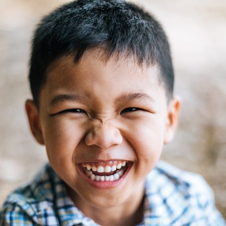 Child smiling in dental chair