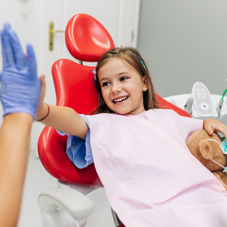 Girl with toothache in dental chair