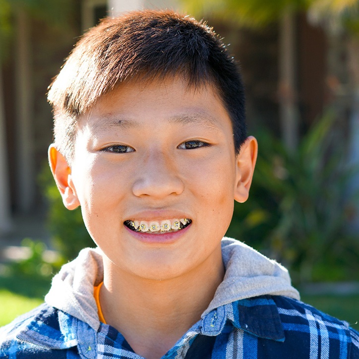 Teenage boy outside smiling with braces in Long Beach, NY