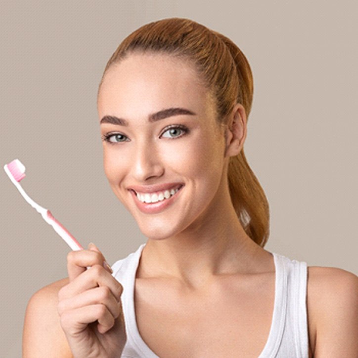 Woman holding toothbrush