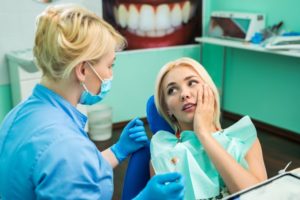 Pained woman visiting her Long Beach emergency dentist