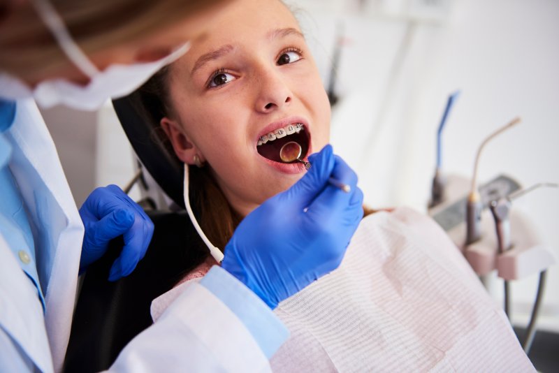 A child about to have their braces removed