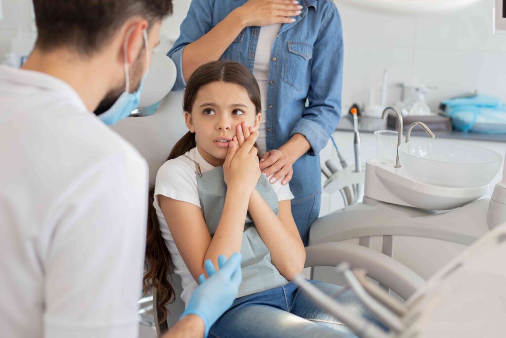 Child with a toothache at the dentist