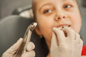 Child having tooth extracted.