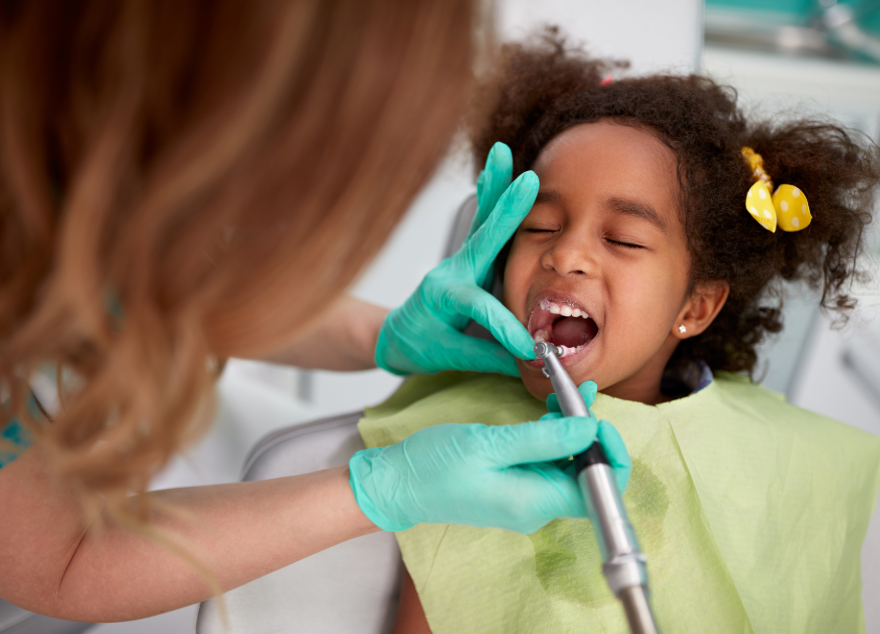 Little girl in dental chair undergoing exam